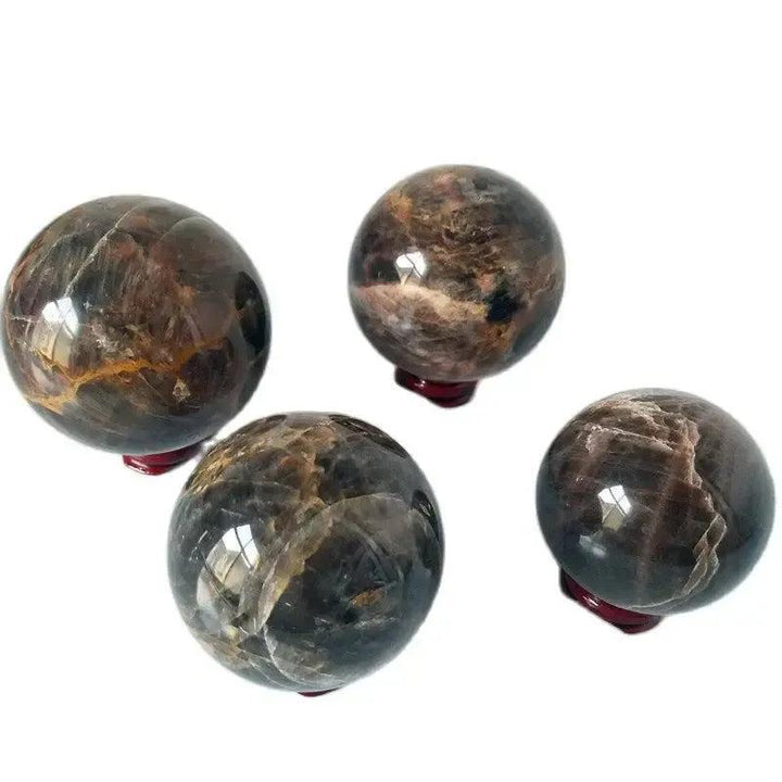 Four polished Gray Moonstone crystal spheres from Crystal Destiny, showcasing silvery-gray shimmer and adularescence.