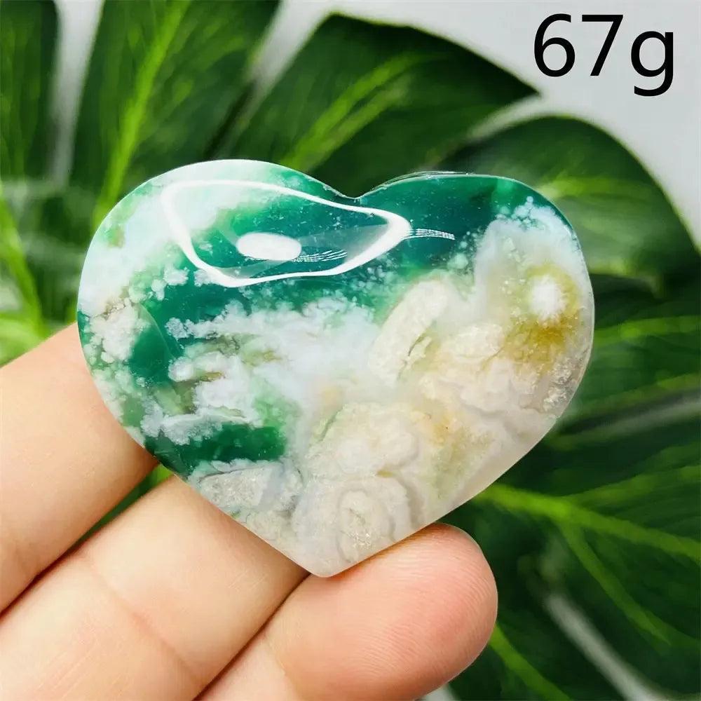 Hand-carved Green Agate Crystal Heart with intricate flower design, showcasing natural green banding and translucent beauty.