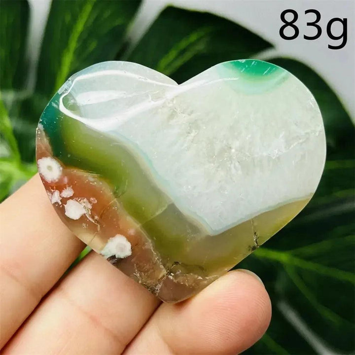 Green Agate Crystal Heart, hand-carved with natural green banding, white, and brown hues, promoting growth and emotional balance.
