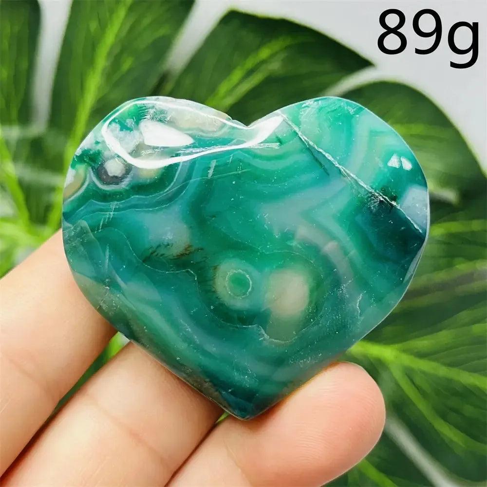 Green Agate Crystal Heart, hand-carved with unique green banding, promoting growth, abundance, and emotional balance.