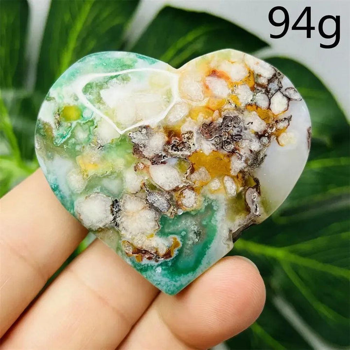 Green Agate Crystal Heart: Hand-carved, polished heart with vibrant green, white, and orange hues, promoting emotional balance.