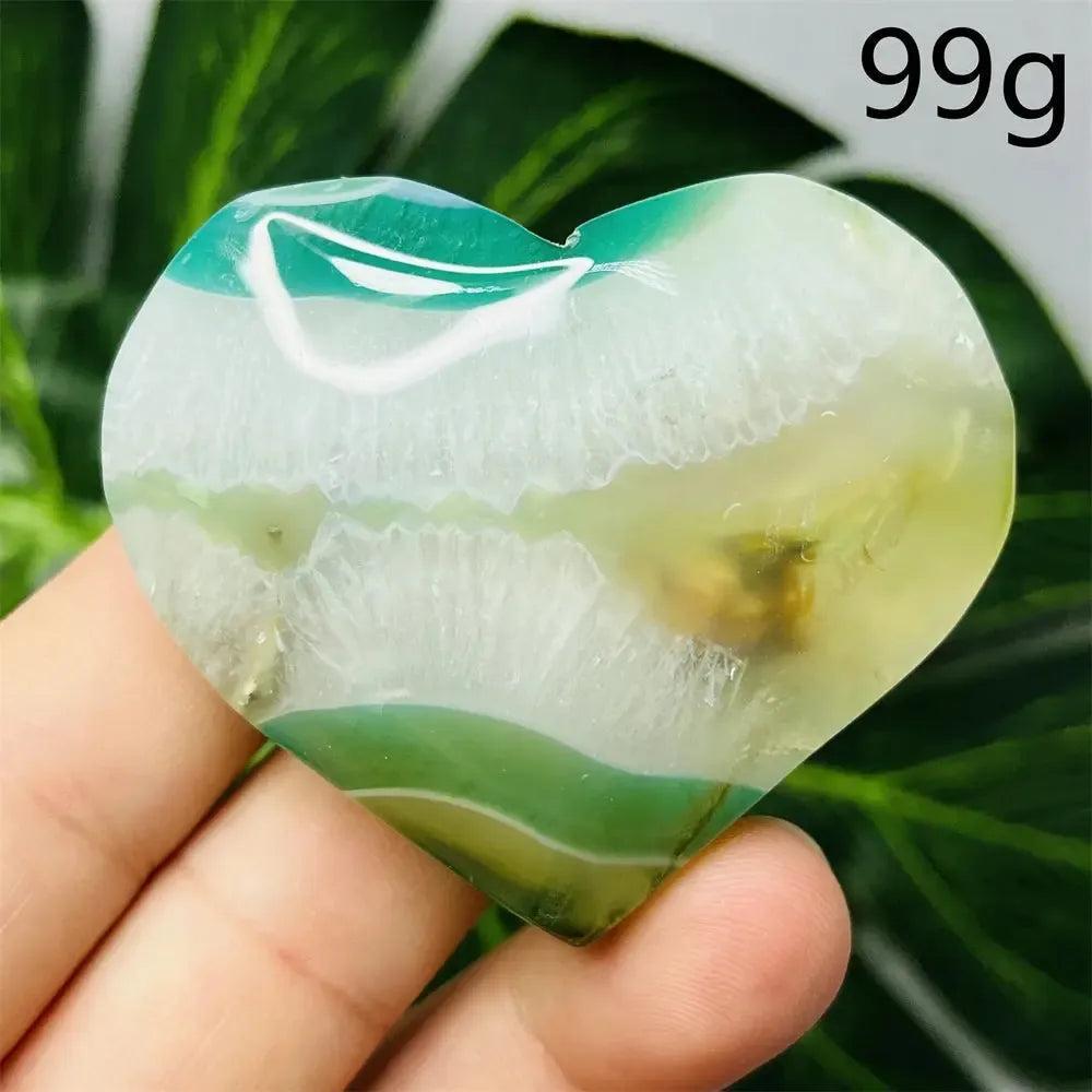Green Agate Crystal Heart, hand-carved with natural green banding, promoting growth, abundance, and emotional balance.