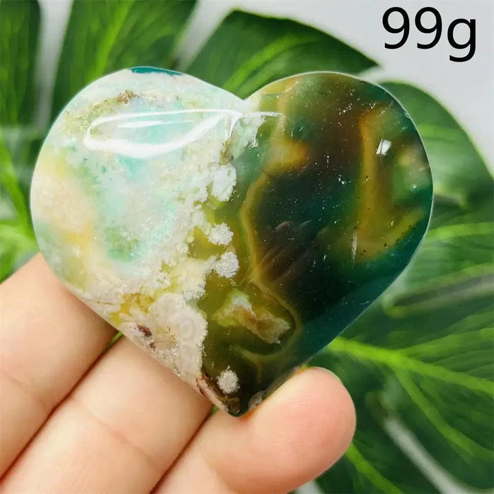 Hand-carved Green Agate Crystal Heart with unique green, white, and brown banding, symbolizing growth and emotional balance.