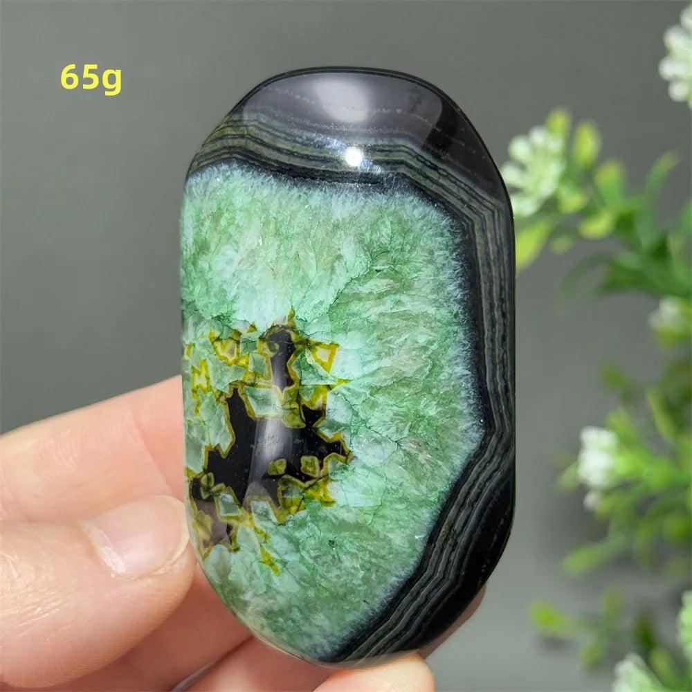 Polished 65g natural green agate palm stone with striking black banding, perfect for healing, meditation, and decor.