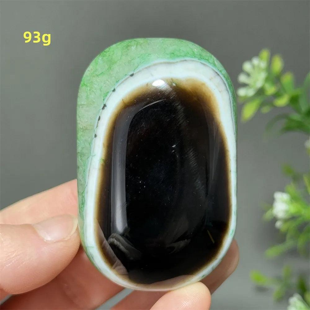 Polished 93g natural green agate palm stone with a striking black center, perfect for Reiki, meditation, and healing.