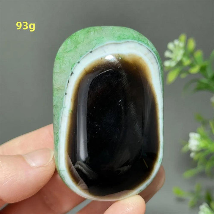 Polished 93g natural green agate palm stone with a striking black center, perfect for Reiki, meditation, and healing.