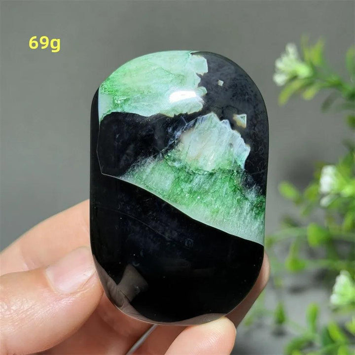 Polished 69g natural green agate palm stone with striking black and vibrant green patterns for healing and meditation.
