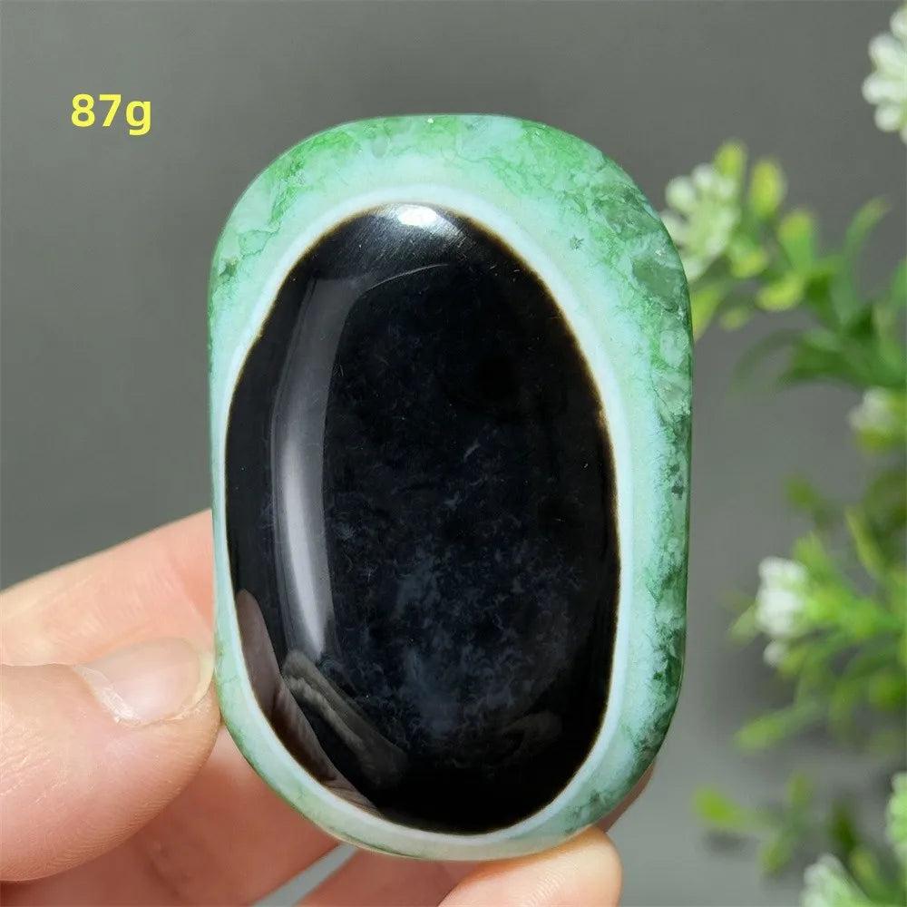 87g natural green agate palm stone with a polished black center, perfect for reiki healing and spiritual meditation.