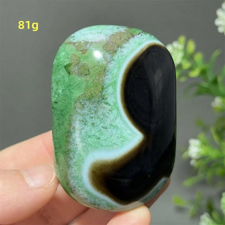 Polished 81g natural green agate palm stone with unique black banding for reiki healing, meditation, and home decor.