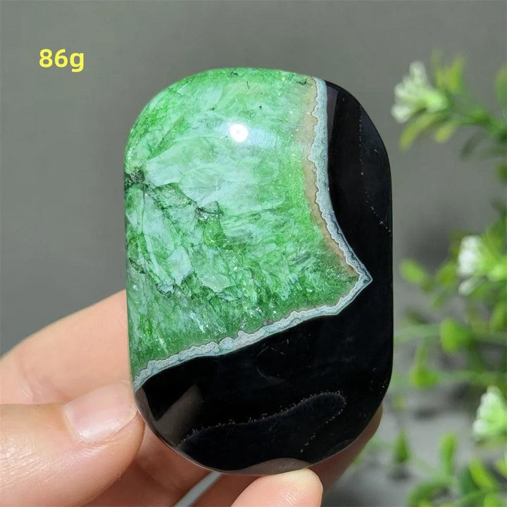 Polished 86g natural green agate palm stone with striking black contrast, perfect for reiki, meditation, and healing.