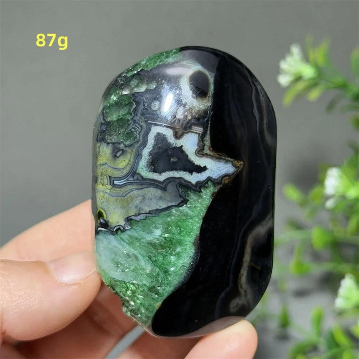 Polished 87g natural green agate palm stone with striking black patterns, perfect for healing, meditation, and decor.