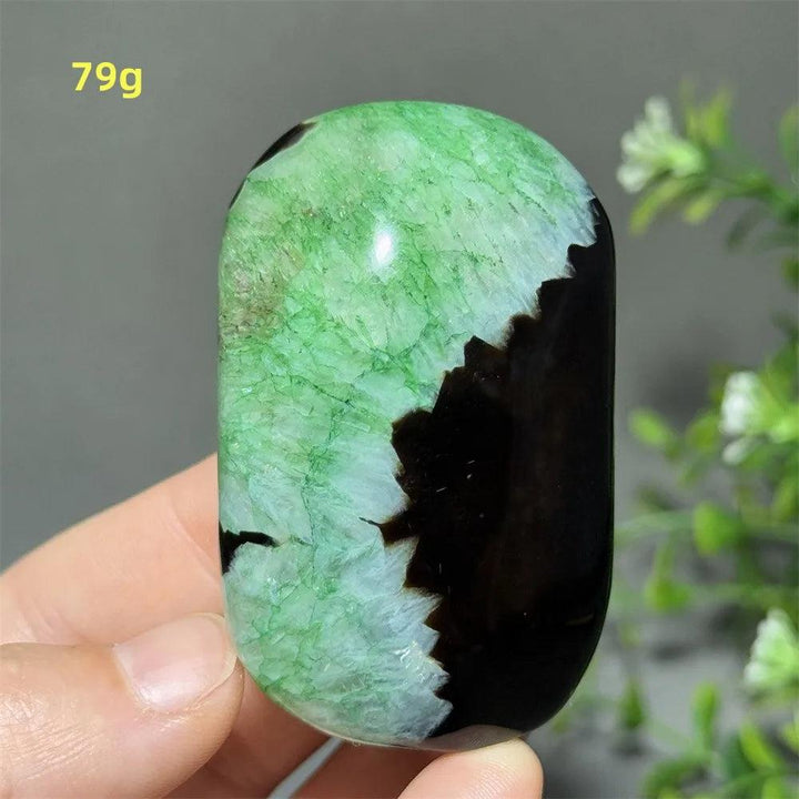 Polished 79g natural green agate palm stone with striking black inclusions, perfect for meditation and healing energy.
