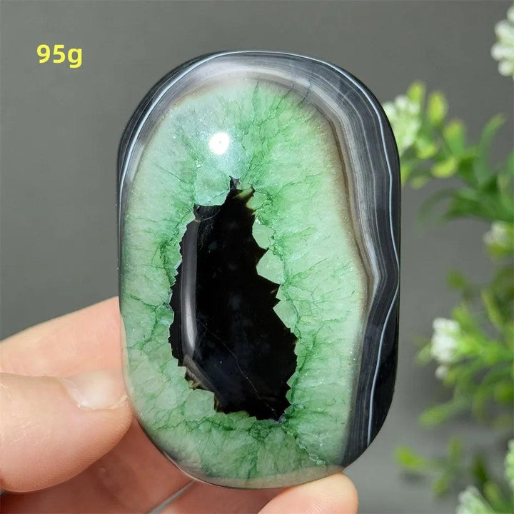 95g polished natural green agate palm stone with a striking black geode center for healing, meditation, and decor.