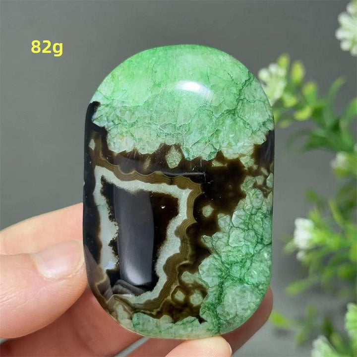 Polished 82g natural green agate palm stone with unique black banding for reiki healing, meditation, and home decor.