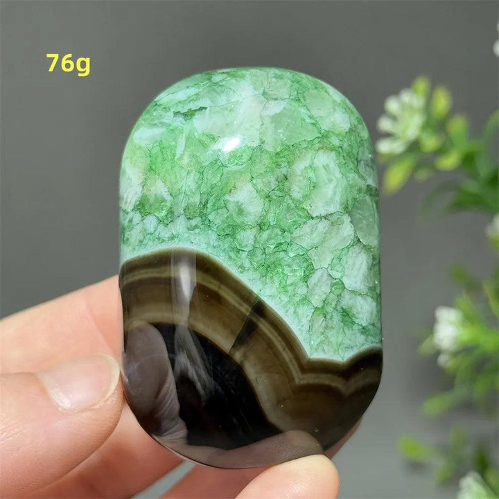 Polished 76g natural green agate palm stone with unique banded patterns, perfect for reiki, meditation, and healing.