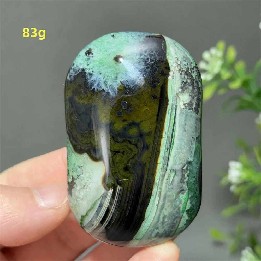 Polished 83g natural green agate palm stone with unique dark mossy patterns, perfect for healing, meditation, and decor.