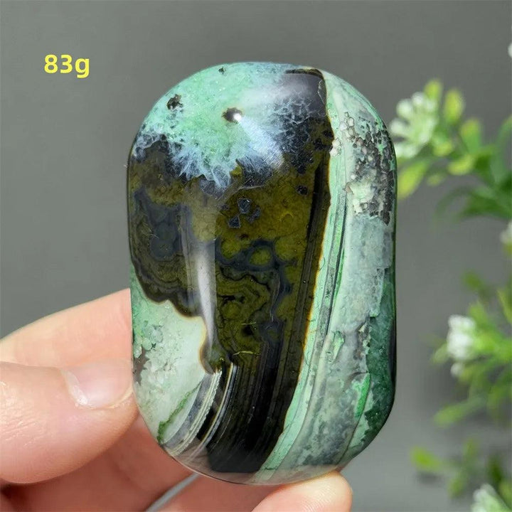 Polished 83g natural green agate palm stone with unique dark mossy patterns, perfect for healing, meditation, and decor.
