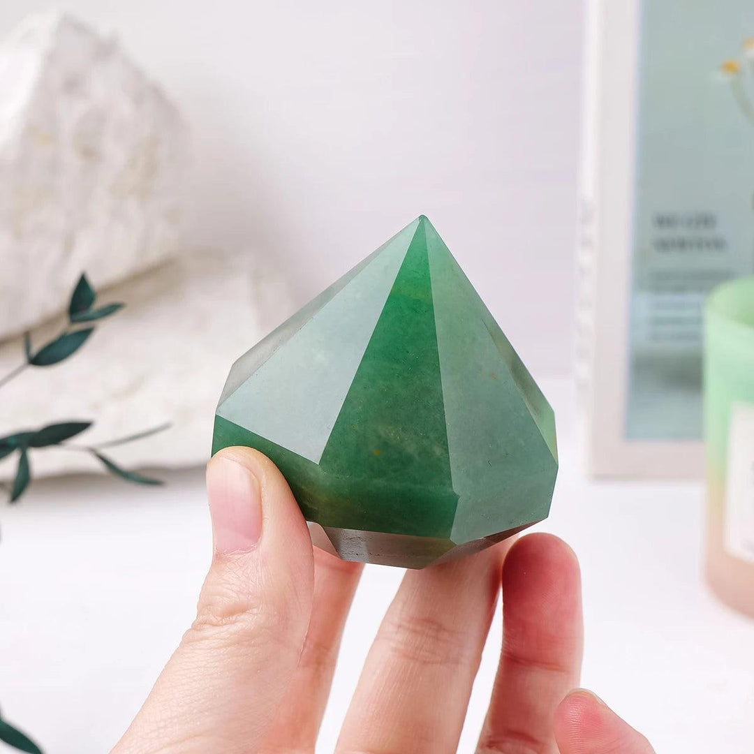 Handheld green aventurine quartz crystal pyramid for Reiki healing, meditation, and balancing home decor.