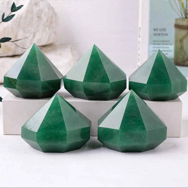Five polished green aventurine quartz crystal pyramids for Reiki healing, meditation, and Feng Shui home decor.