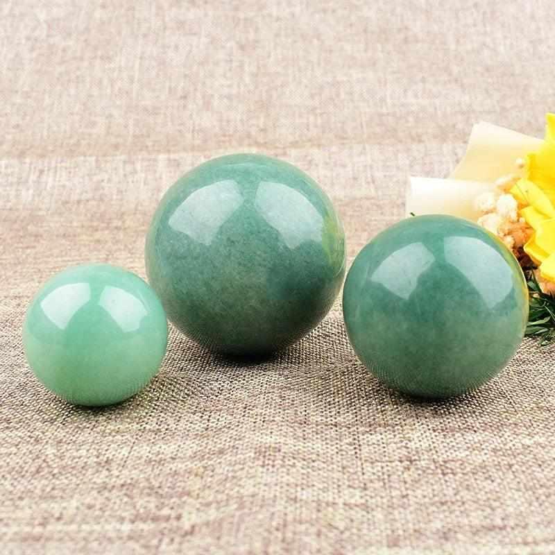 Polished Green Aventurine spheres in three sizes, featuring a fresh green hue and soft shimmer for Heart Chakra healing.