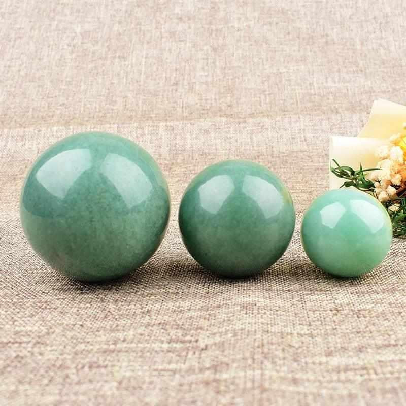 Polished Green Aventurine spheres in various sizes, featuring a vibrant green hue and shimmering mica for heart chakra healing.