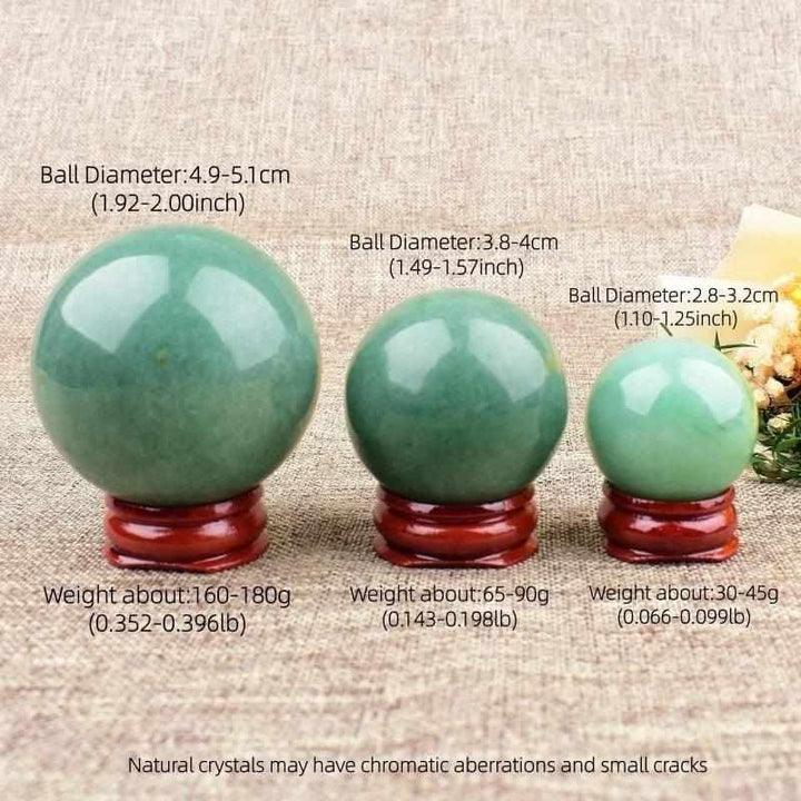 Three polished Green Aventurine spheres in varying sizes on wooden stands, showcasing natural green shimmer and texture.