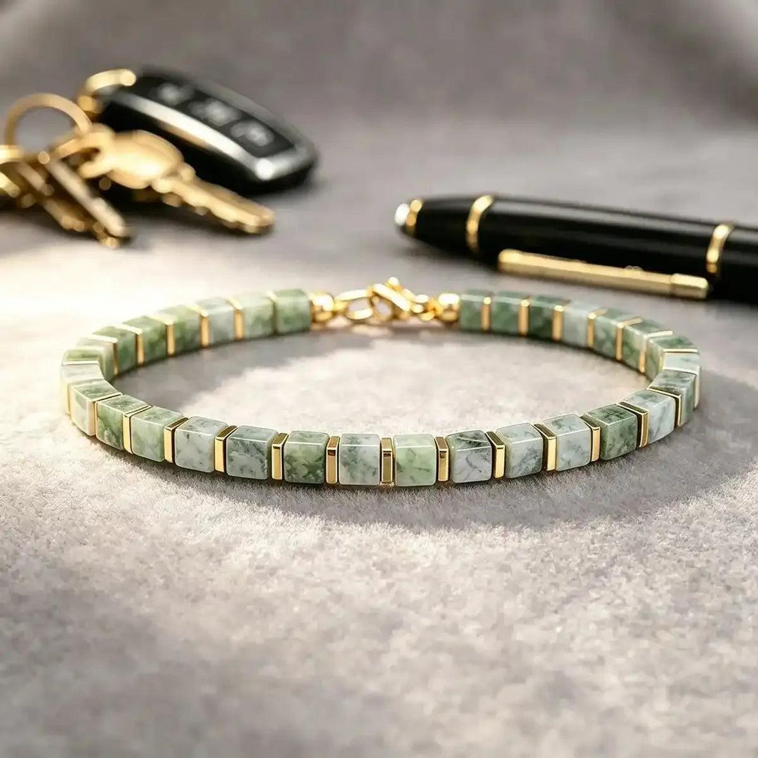 Green Aventurine square bead bracelet with gold-tone spacers, promoting heart chakra balance in a geometric design.