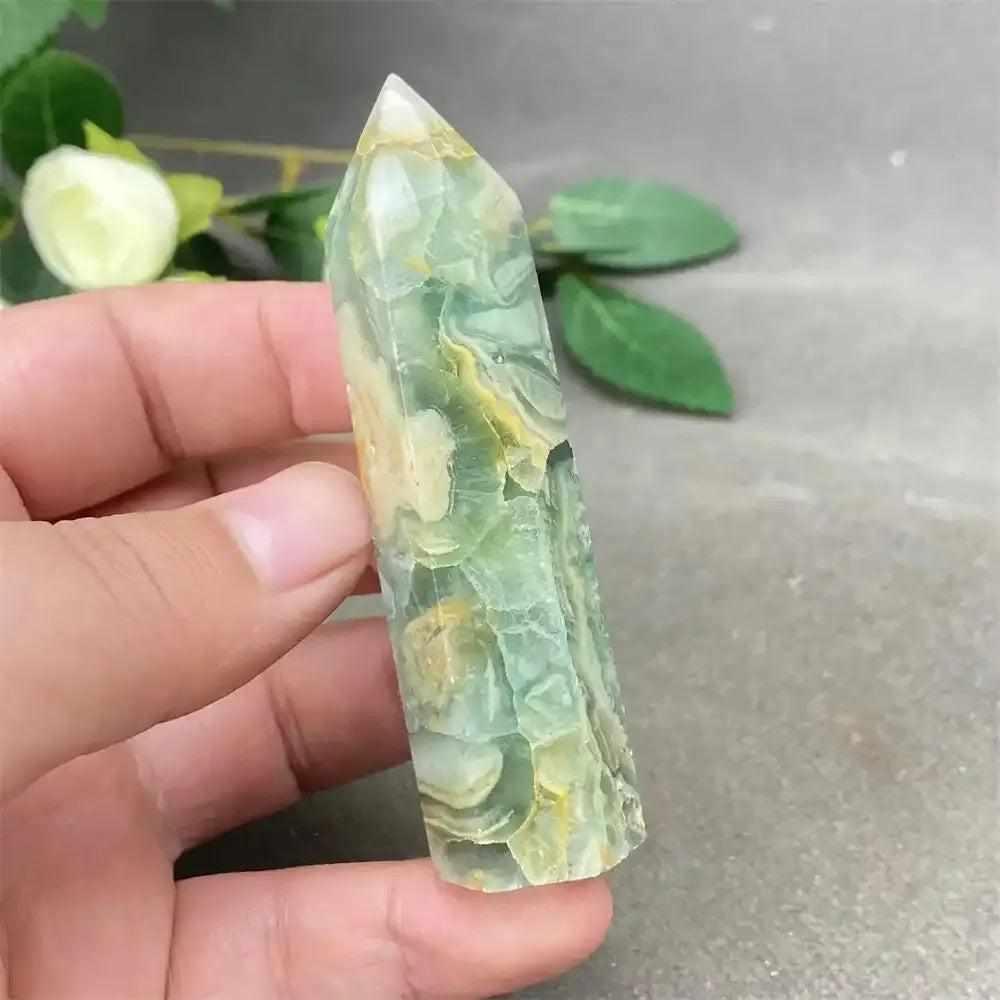 Hand-polished green calcite tower with soft banding and a faceted point for heart chakra renewal and emotional balance.