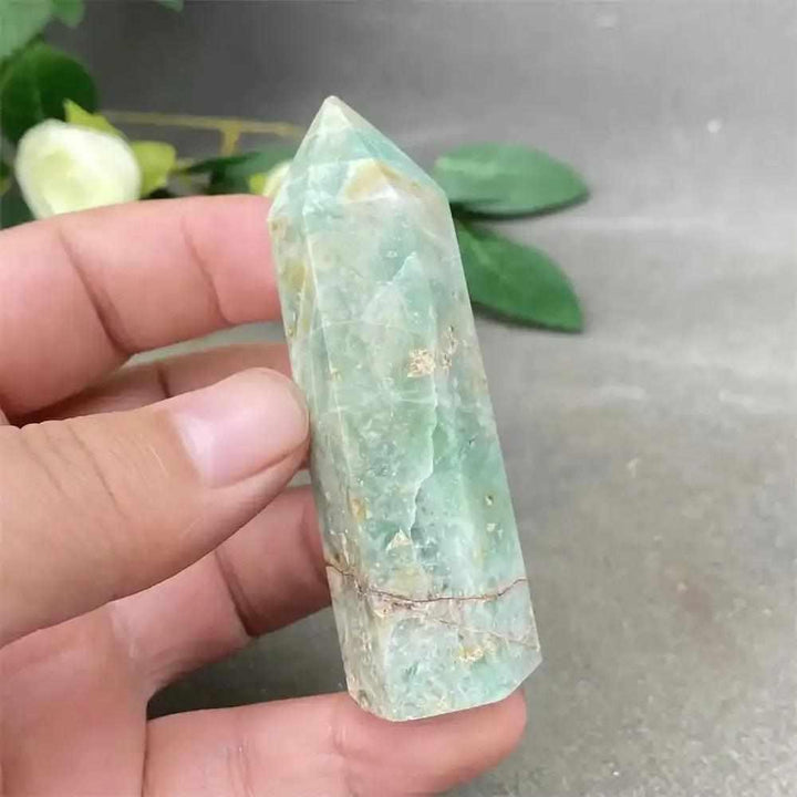 Hand-polished Green Calcite tower with natural banding and a faceted point for Heart chakra renewal and emotional balance.