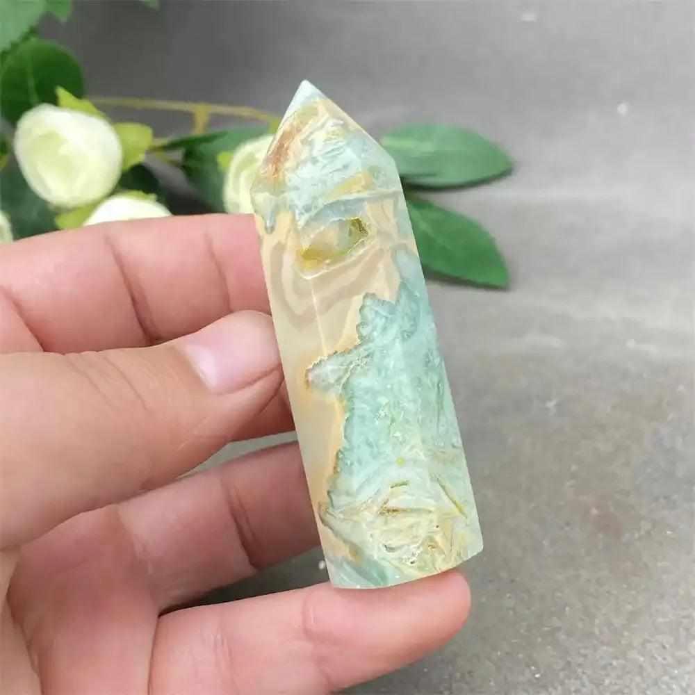 Hand-polished green calcite tower with soft banding and a faceted point for Heart chakra healing and emotional balance.