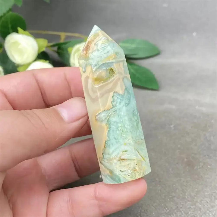Hand-polished green calcite tower with soft banding and a faceted point for Heart chakra healing and emotional balance.
