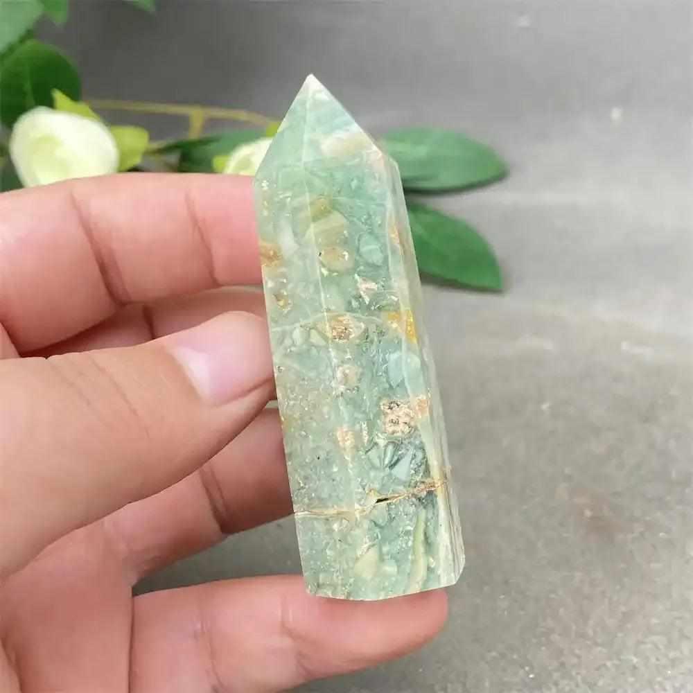 Hand-polished Green Calcite tower featuring soft green hues, natural banding, and a faceted point for Heart chakra healing.