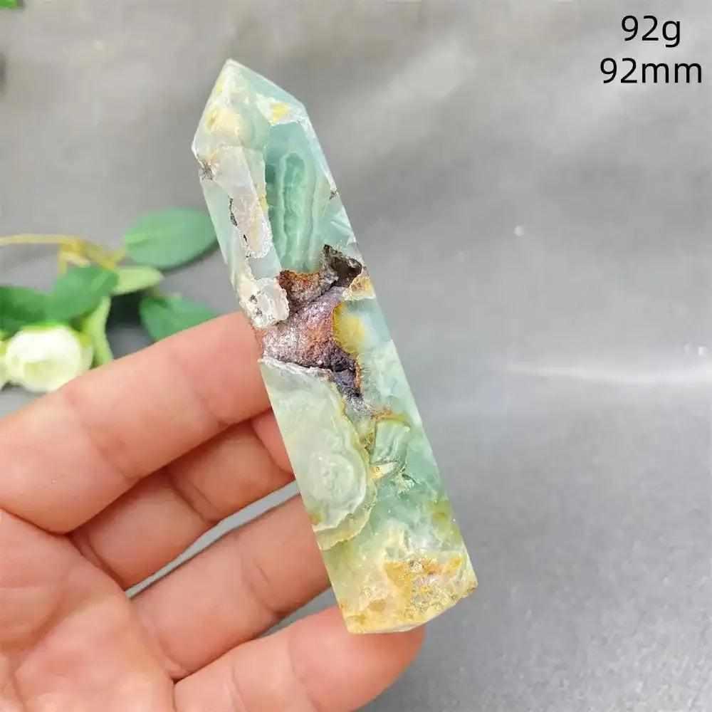Hand-polished Green Calcite tower with soft green banding, natural veils, and a faceted point for Heart chakra healing.