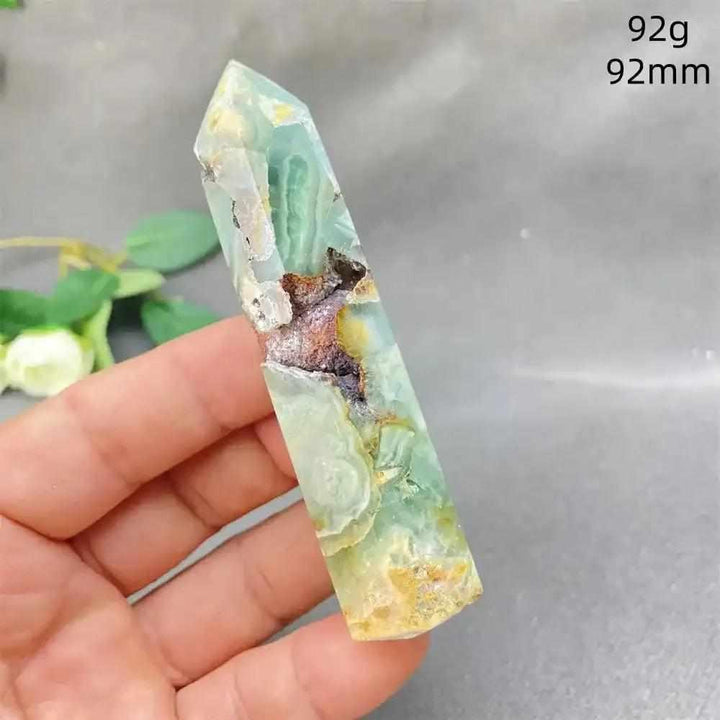 Hand-polished Green Calcite tower with soft green banding, natural veils, and a faceted point for Heart chakra healing.