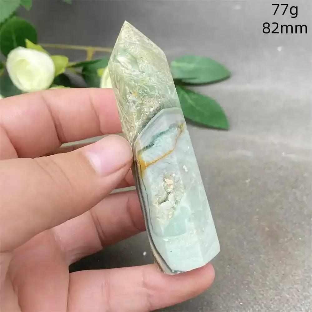 Hand-polished Green Calcite tower with natural banding and a faceted point for Heart chakra renewal and emotional balance.