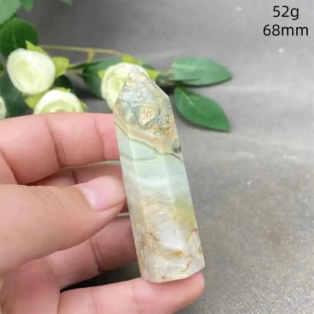 Hand-polished Green Calcite tower featuring soft green banding and natural veils for Heart chakra healing and balance.