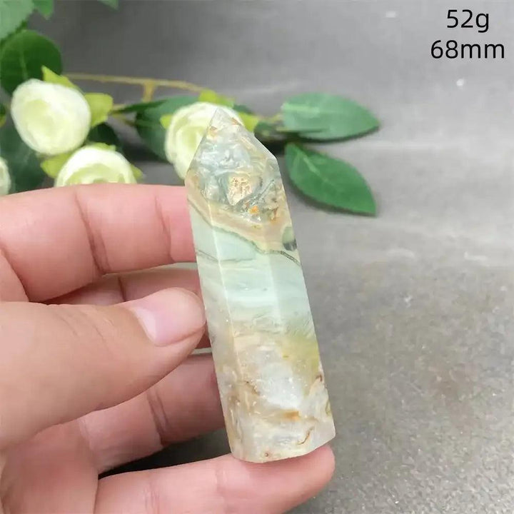 Hand-polished Green Calcite tower featuring soft green banding and natural veils for Heart chakra healing and balance.