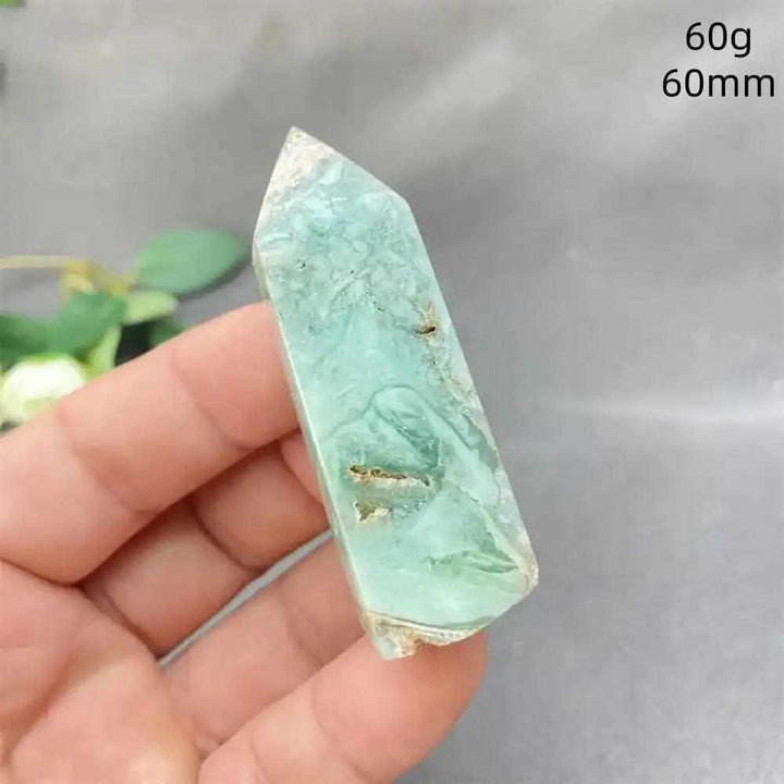 Hand-polished Green Calcite tower with soft green banding and a faceted point for Heart chakra meditation and renewal.