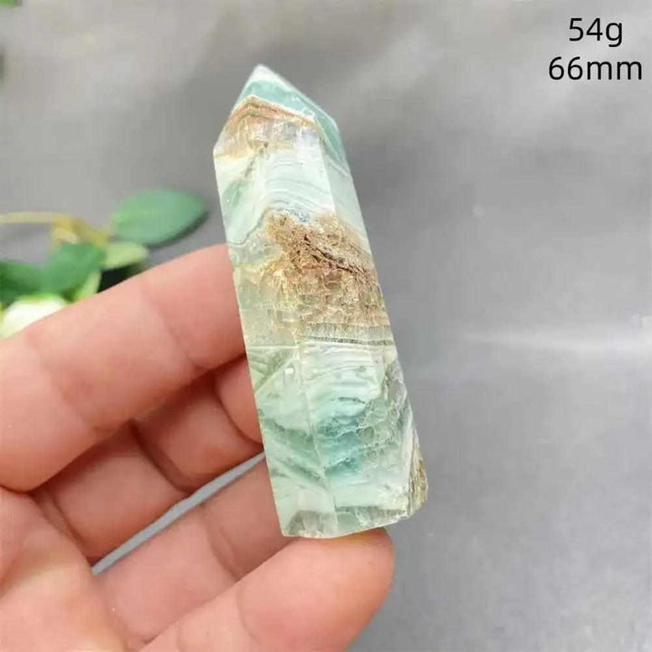 Hand-polished Green Calcite tower with soft green banding and natural veils for Heart chakra balance and renewal.