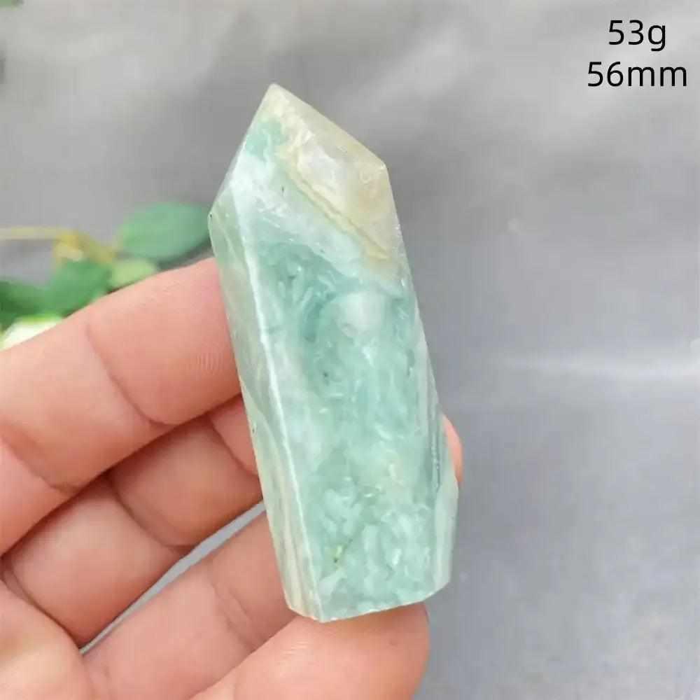 Hand-polished Green Calcite tower with soft green banding and a faceted point for Heart chakra renewal and calm energy.