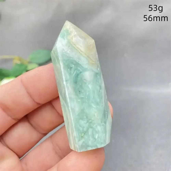 Hand-polished Green Calcite tower with soft green banding and a faceted point for Heart chakra renewal and calm energy.