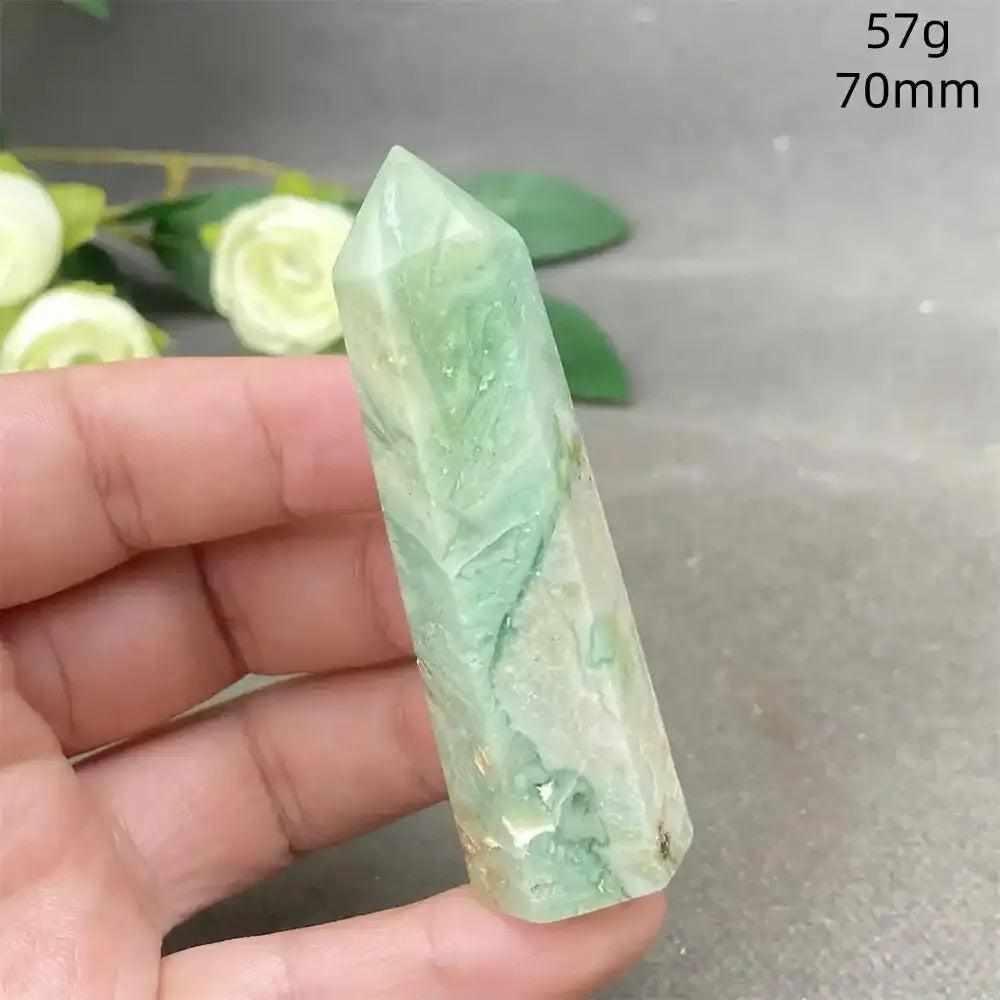 Hand-polished green calcite tower with natural banding and a waxy glow, perfect for heart chakra renewal and meditation.