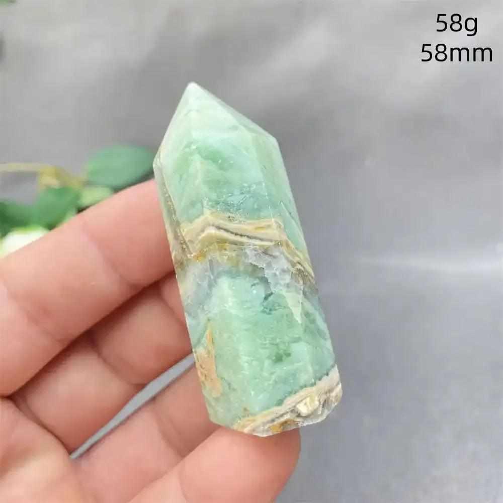 Hand-polished green calcite tower with natural banding and a faceted point for Heart chakra renewal and emotional balance.
