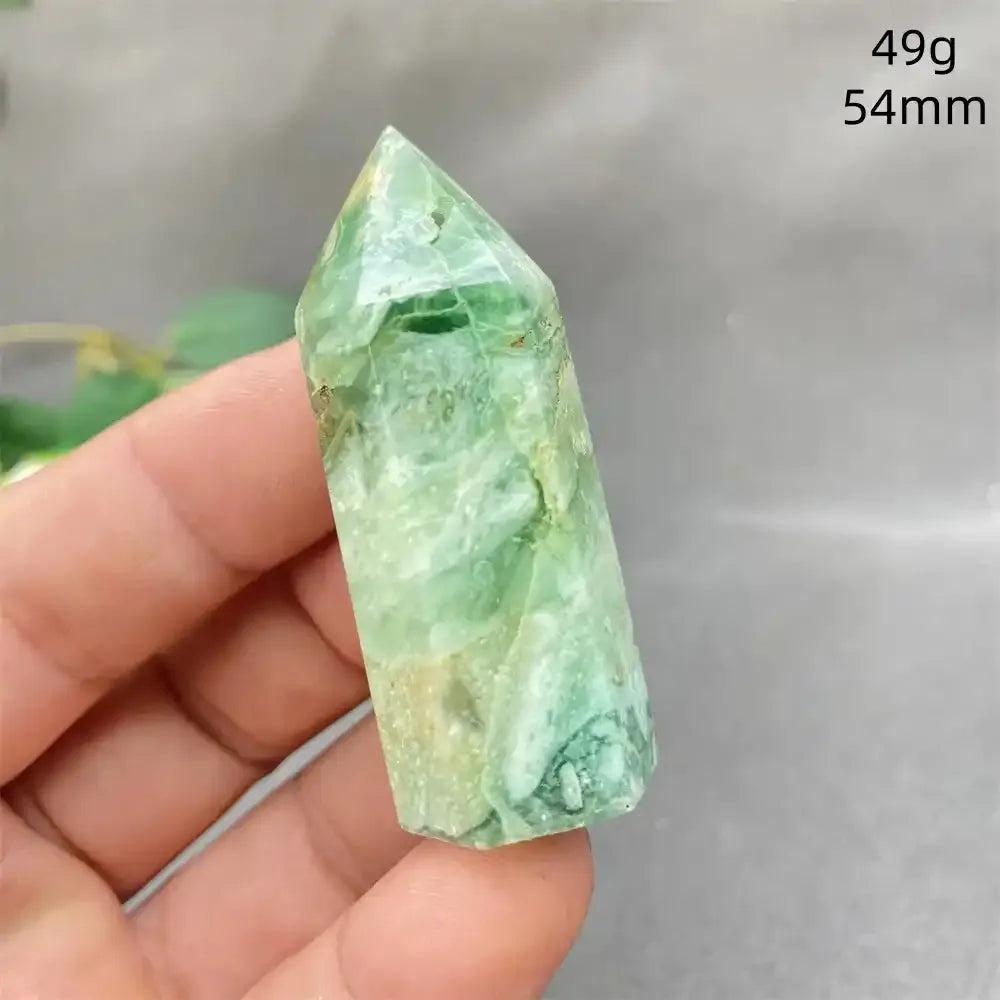 Hand-polished Green Calcite tower with soft green banding and a faceted point for Heart chakra renewal and calm energy.