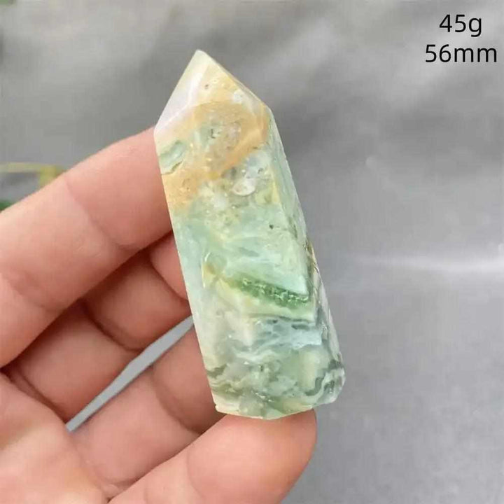 Hand-polished Green Calcite tower with soft green banding and a faceted point for Heart chakra healing and renewal.