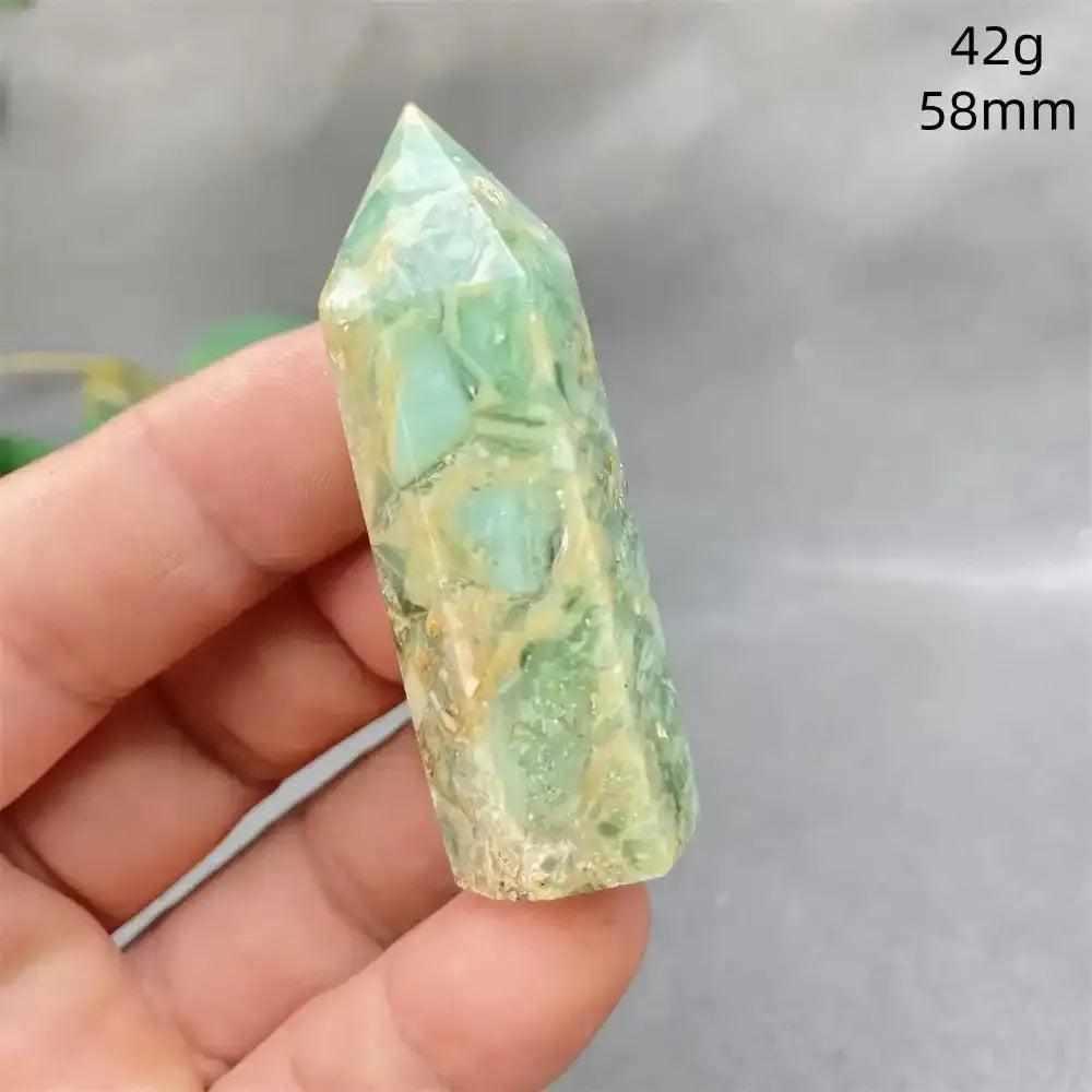 Hand-polished Green Calcite tower with soft green banding and a faceted point for Heart chakra healing and renewal.