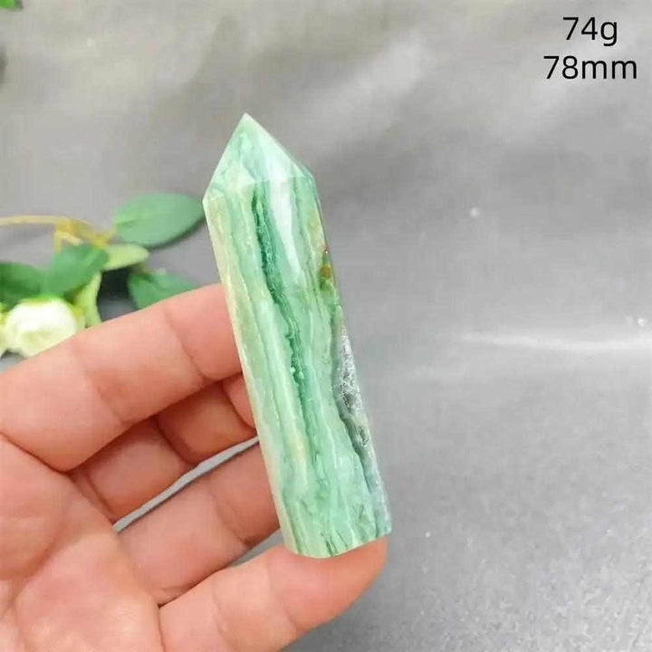 Hand-polished green calcite tower with soft banding and a faceted point, perfect for Heart chakra healing and balance.