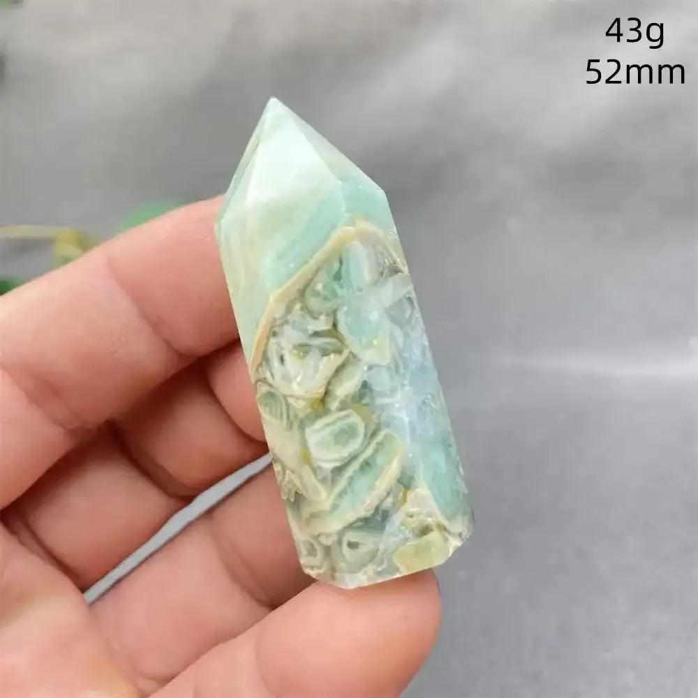 Hand-polished Green Calcite tower with soft green banding and a faceted point for Heart chakra healing and renewal.