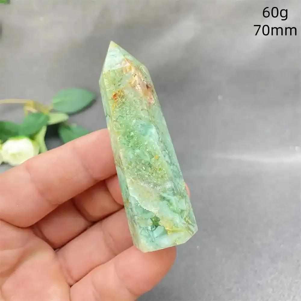 Hand-polished green calcite tower with natural banding and a waxy glow, perfect for heart chakra healing and meditation.