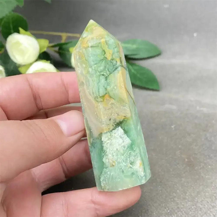 Hand-polished Green Calcite tower featuring soft green hues, natural banding, and a faceted point for Heart chakra healing.